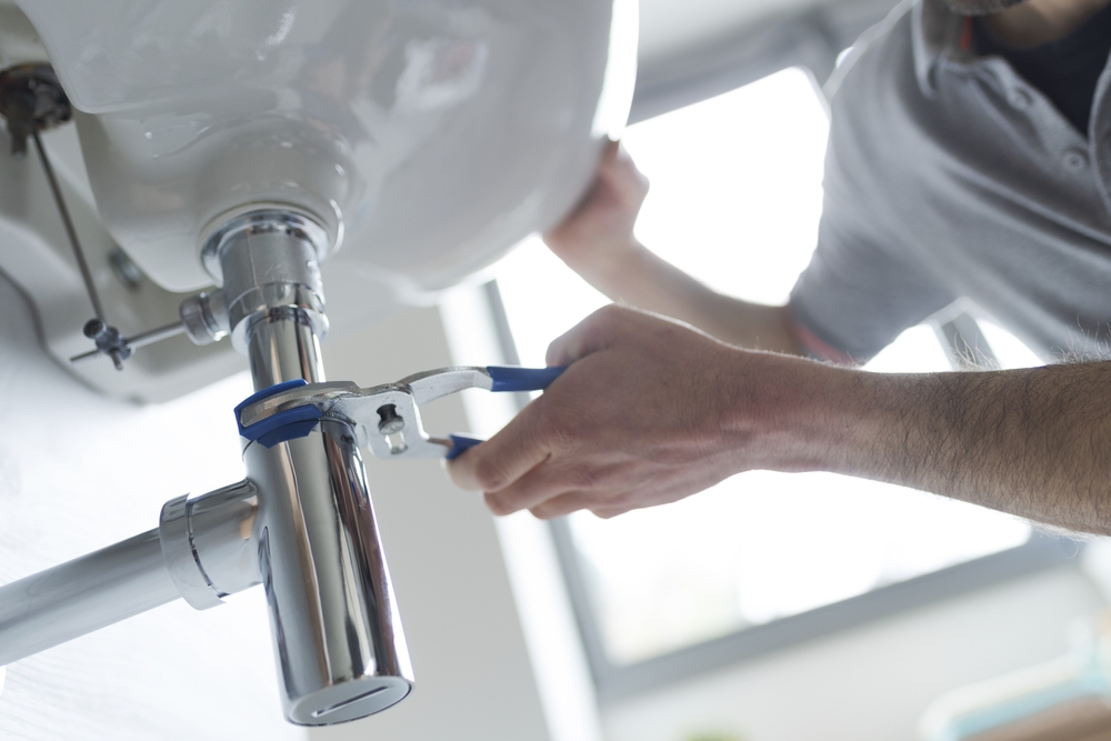 Professional,Plumber,Fixing,A,Leaking,Bathroom,Sink,,He,Is,Using